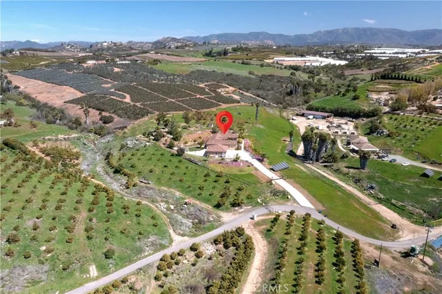 a view of a house with a yard and garden