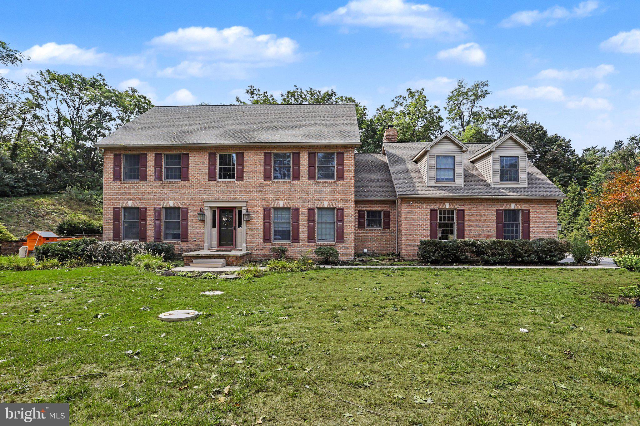 2005 Woodberry Road York, PA 17408 - Photo 2 of 33 Charming brick home with lush greenery.