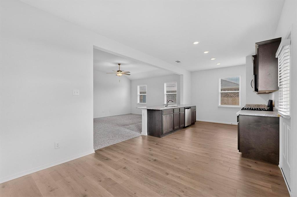 502 Monroe Jackson Street Venus, TX 76084 - Photo 18 of 40 a view of a kitchen with a sink and a refrigerator