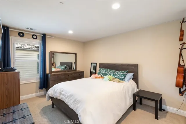 a bedroom with a bed and a chair