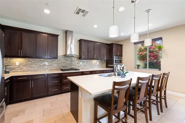 a large kitchen with a table and chairs in it