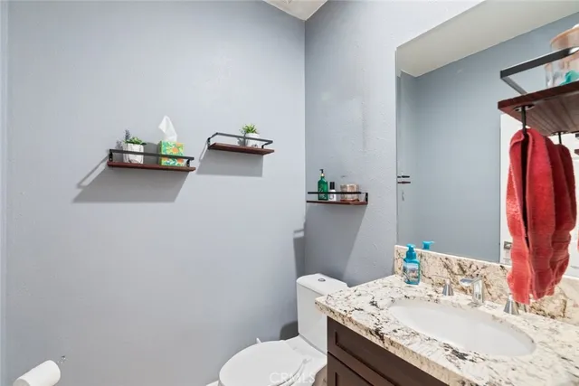 a bathroom with a sink toilet and mirror