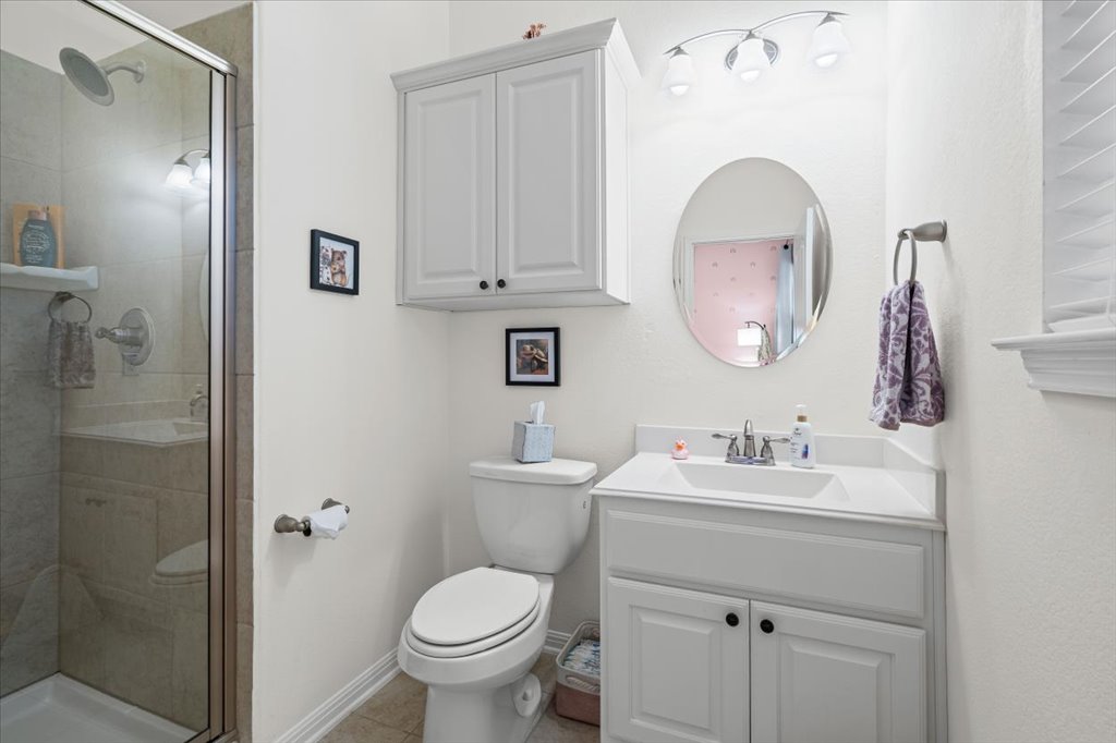 5912 Corrine Lane Austin, TX 78747 - Photo 19 of 27 Full bath featuring a shower stall, connected to the tertiary bedroom.