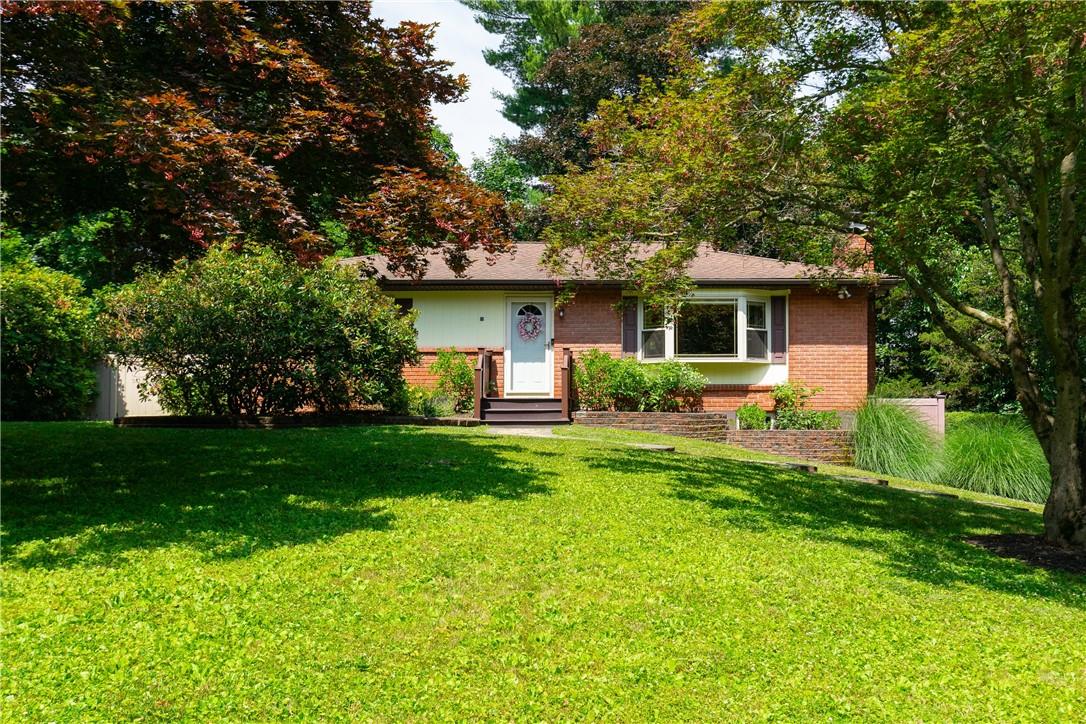 Ranch-style home featuring a front yard