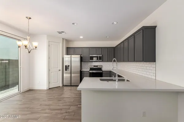 a kitchen with a sink cabinets and stainless steel appliances