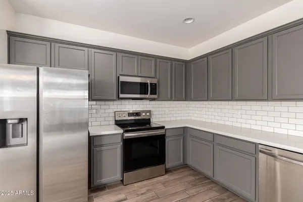 a bathroom with a sink shower and a mirror