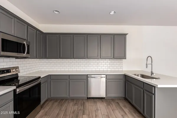 a kitchen with a refrigerator stove and microwave