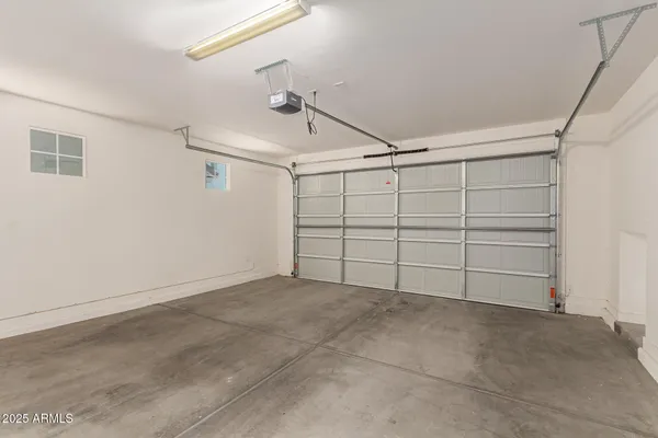 a view of a patio with a table and chairs under an umbrella