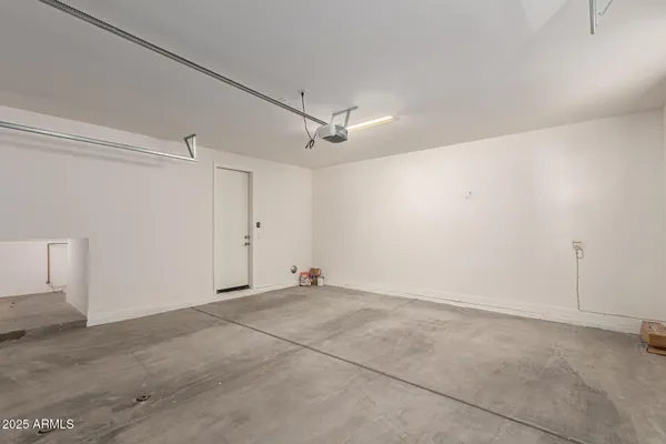 a view of a patio with table and chairs and potted plants