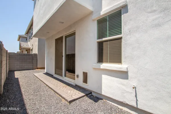 a view of a patio with table and chairs and potted plants