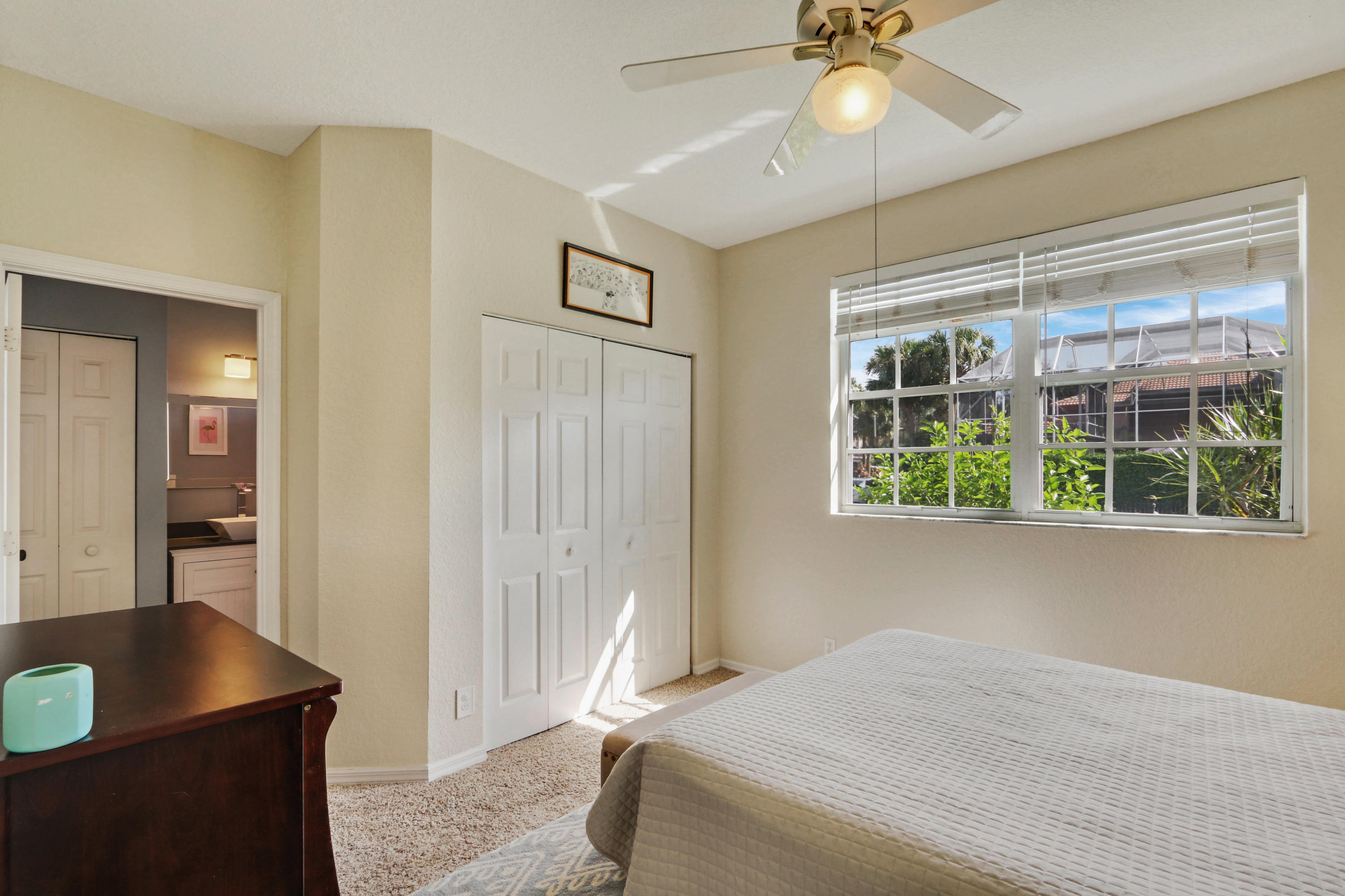 10951 Ravel Court Boca Raton, FL 33498 - Photo 17 of 26 a bedroom with a bed and a chandelier