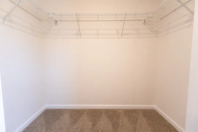 a bathroom with a granite countertop bathtub sink vanity mirror and toilet