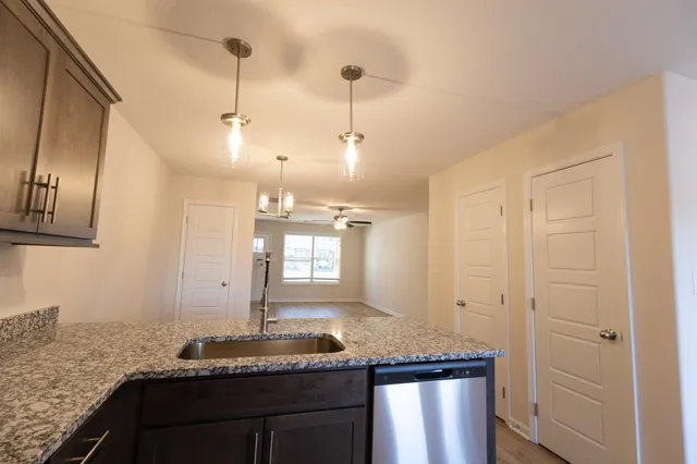 a large kitchen with stainless steel appliances granite countertop a stove and a sink
