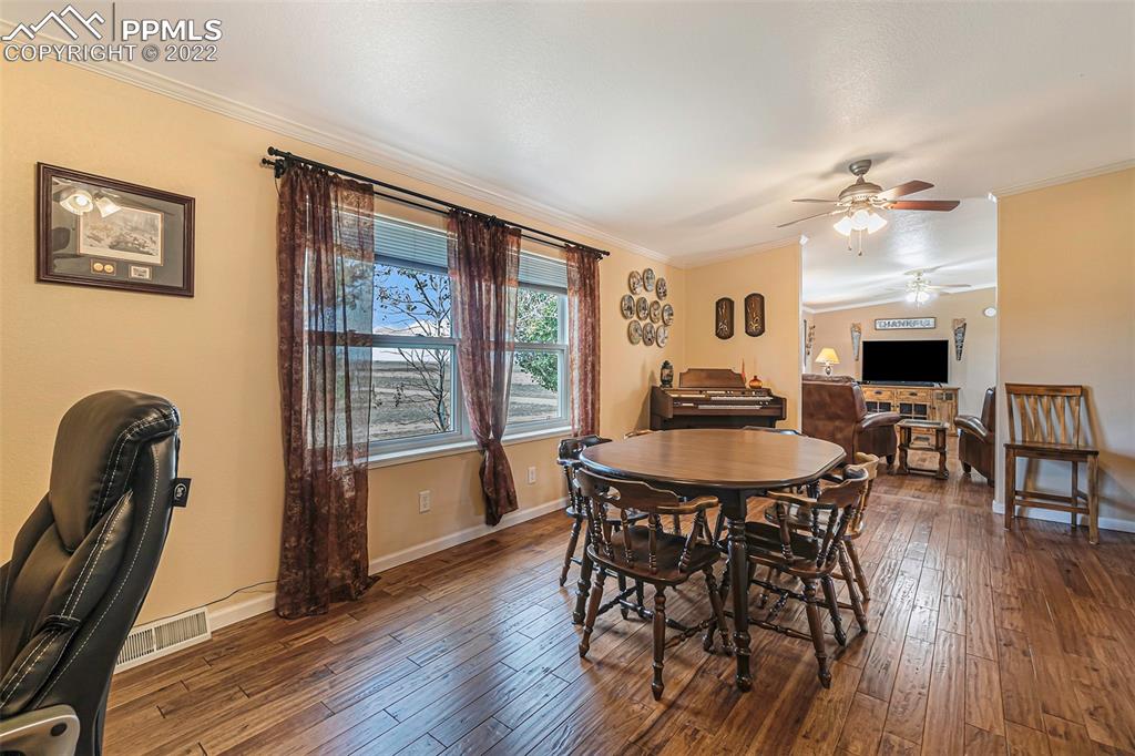 3180 Calhoun Byers Road Byers, CO 80103 - Photo 12 of 48 a view of a a dining room with furniture window and wooden floor