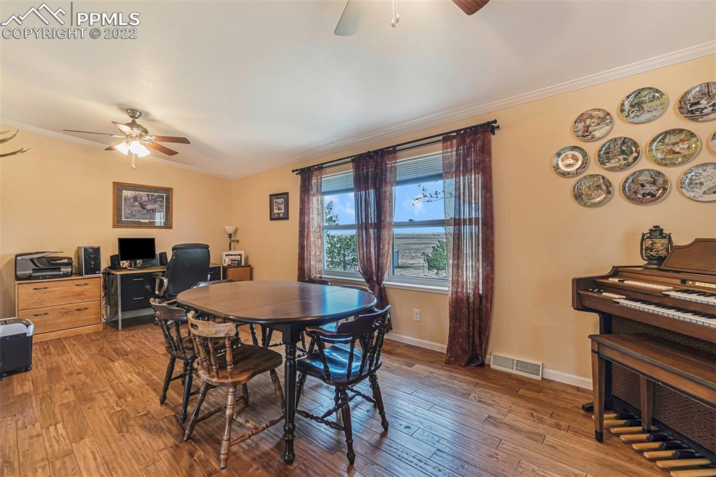 3180 Calhoun Byers Road Byers, CO 80103 - Photo 13 of 48 a view of a dining room with furniture window and wooden floor