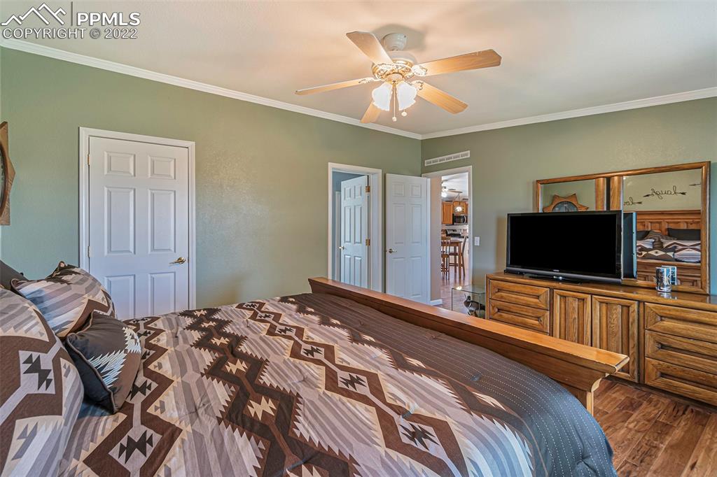 3180 Calhoun Byers Road Byers, CO 80103 - Photo 18 of 48 a bedroom with a bed and a flat screen tv
