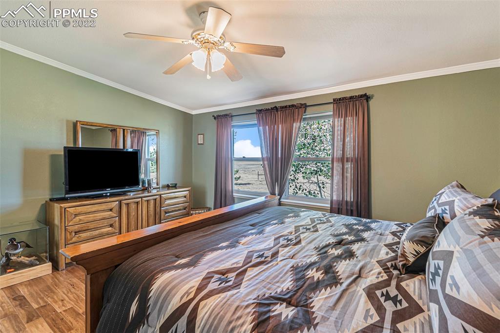 3180 Calhoun Byers Road Byers, CO 80103 - Photo 19 of 48 a bedroom with a bed and a flat screen tv