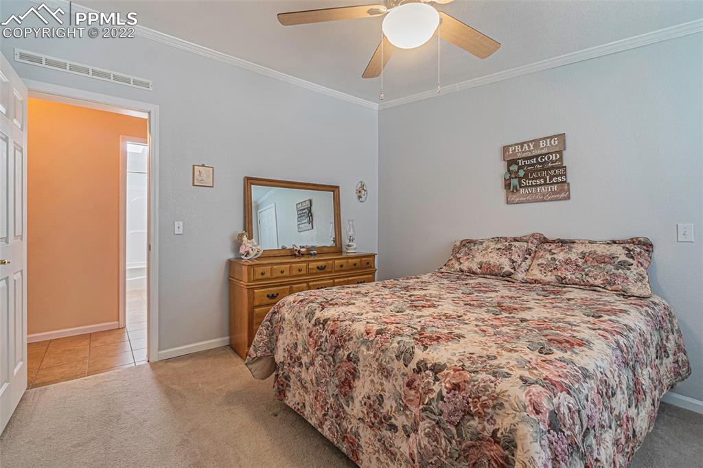 3180 Calhoun Byers Road Byers, CO 80103 - Photo 22 of 48 a bedroom with a bed and a chandelier