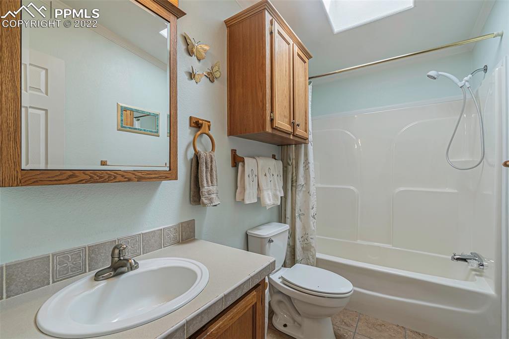 3180 Calhoun Byers Road Byers, CO 80103 - Photo 26 of 48 a bathroom with a sink toilet and shower