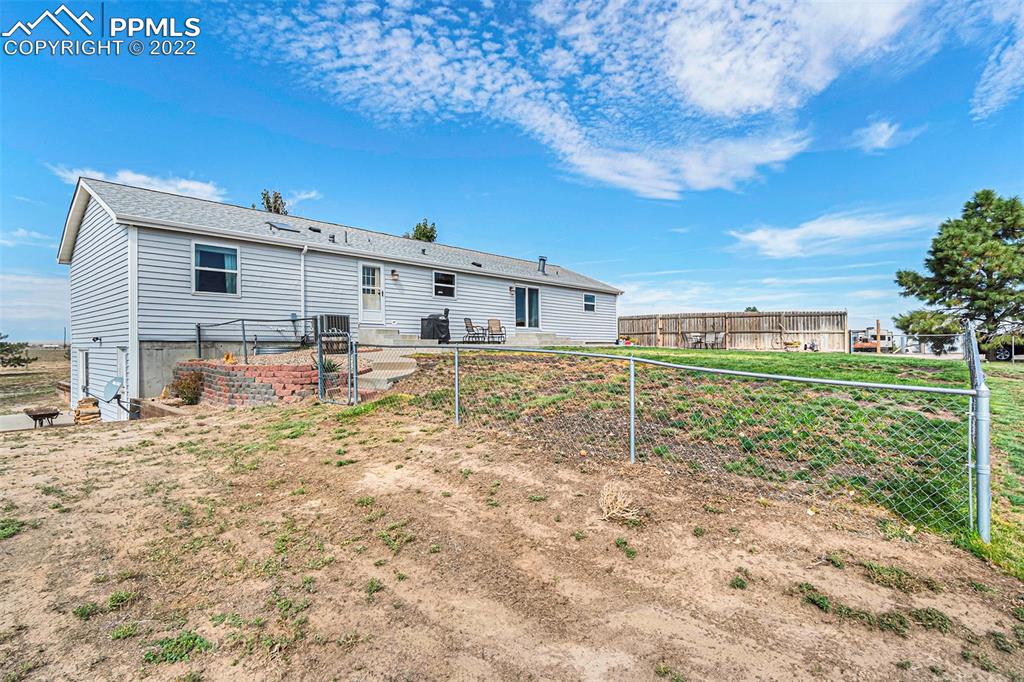 3180 Calhoun Byers Road Byers, CO 80103 - Photo 45 of 48 a view of a house with a yard