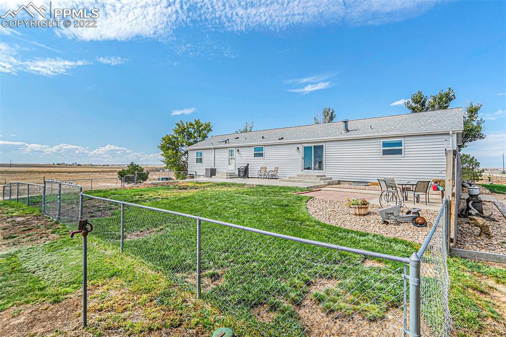3180 Calhoun Byers Road Byers, CO 80103 - Photo 46 of 48 a view of a house with backyard from a patio