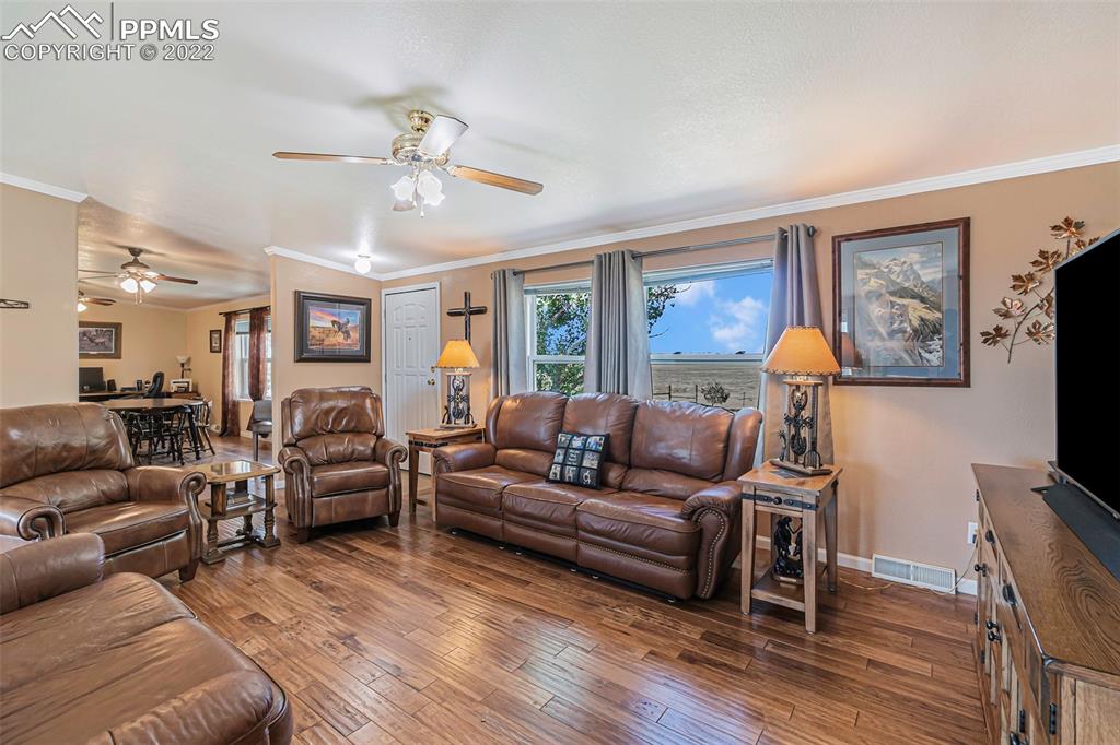 3180 Calhoun Byers Road Byers, CO 80103 - Photo 5 of 48 a living room with furniture flat screen tv and wooden floor