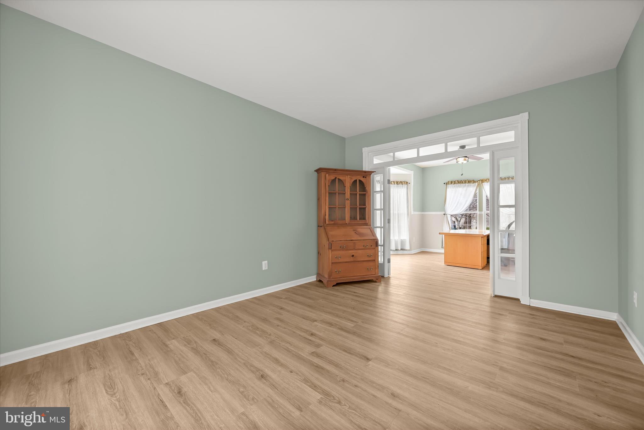 2028 Meadow Tree Court Cooksville, MD 21723 - Photo 12 of 73 a view of an empty room with wooden floor and a window