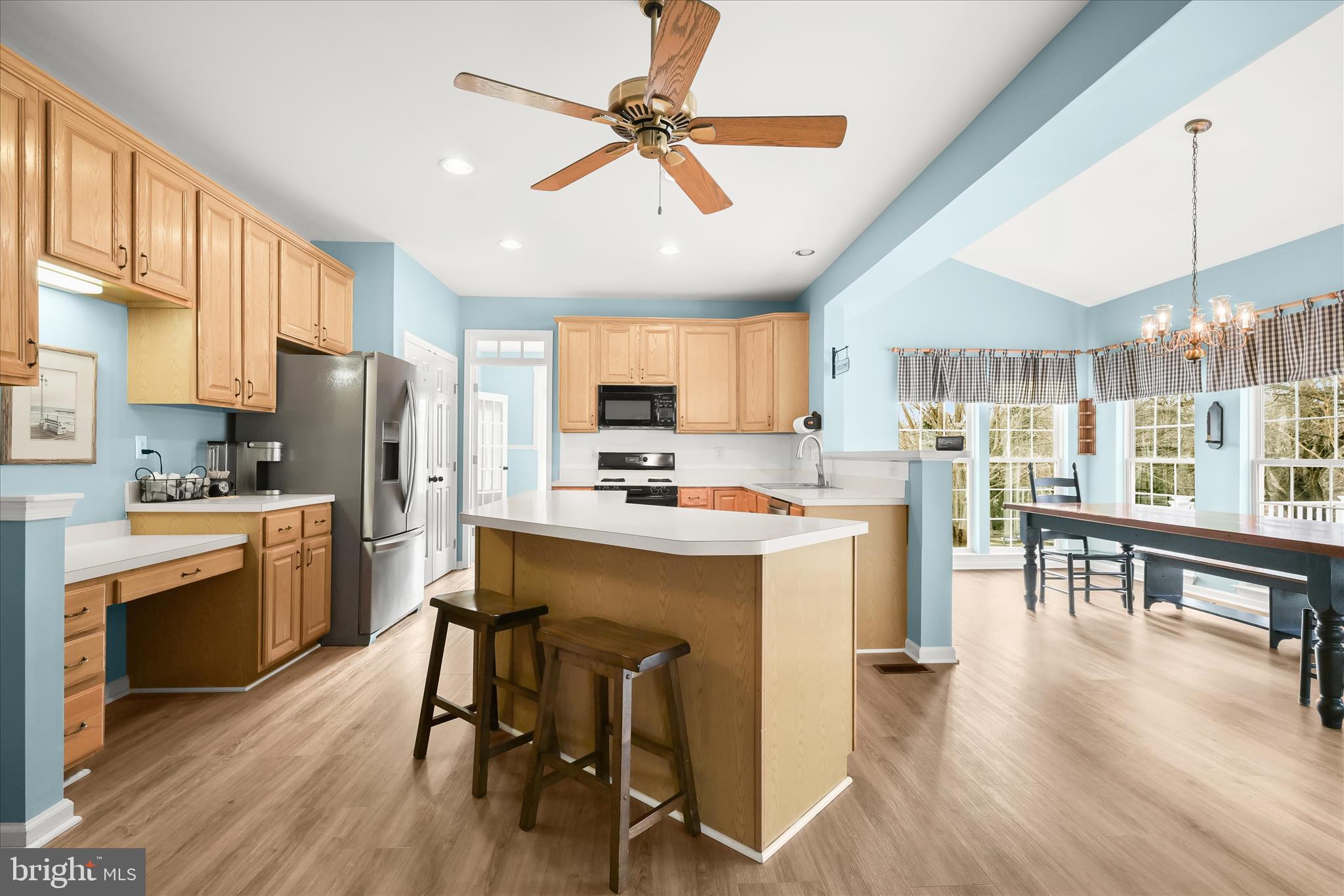 2028 Meadow Tree Court Cooksville, MD 21723 - Photo 4 of 73 a kitchen with refrigerator a stove a sink dishwasher a dining table and chairs with wooden floor