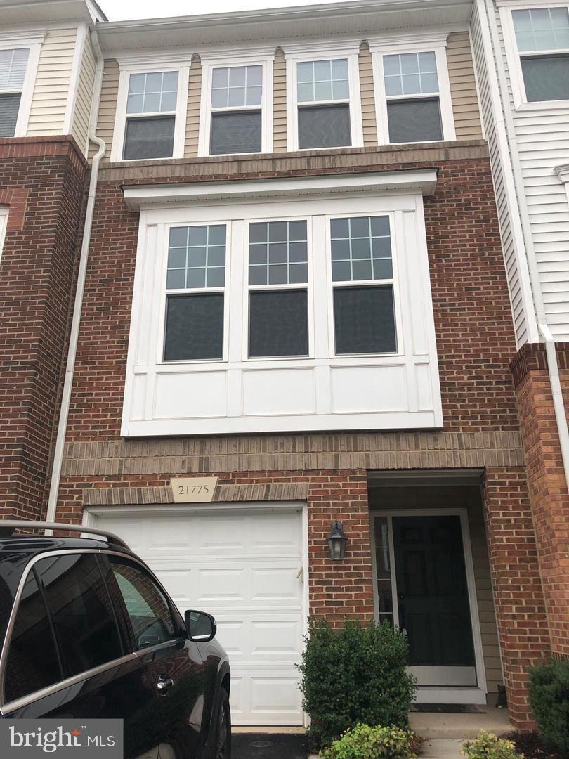 21775 Mears Terrace Ashburn, VA 20147 - Photo 1 of 11 a front view of a house with a parking space
