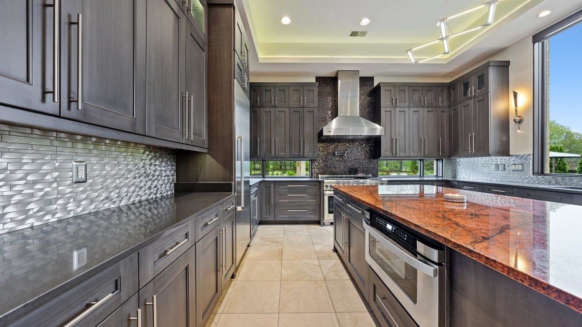 9942 Legends Drive Collierville, TN 38139 - Photo 13 of 40 a kitchen with stainless steel appliances granite countertop a sink and cabinets