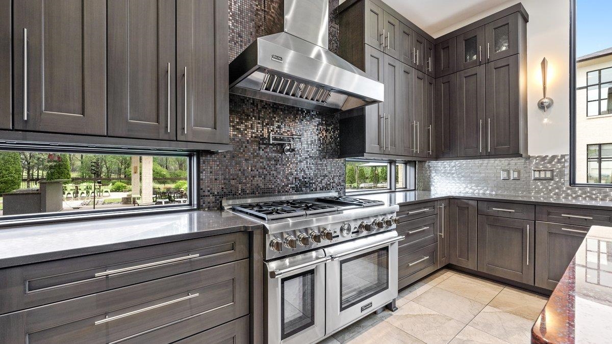 9942 Legends Drive Collierville, TN 38139 - Photo 14 of 40 a kitchen with stainless steel appliances granite countertop a stove and a sink