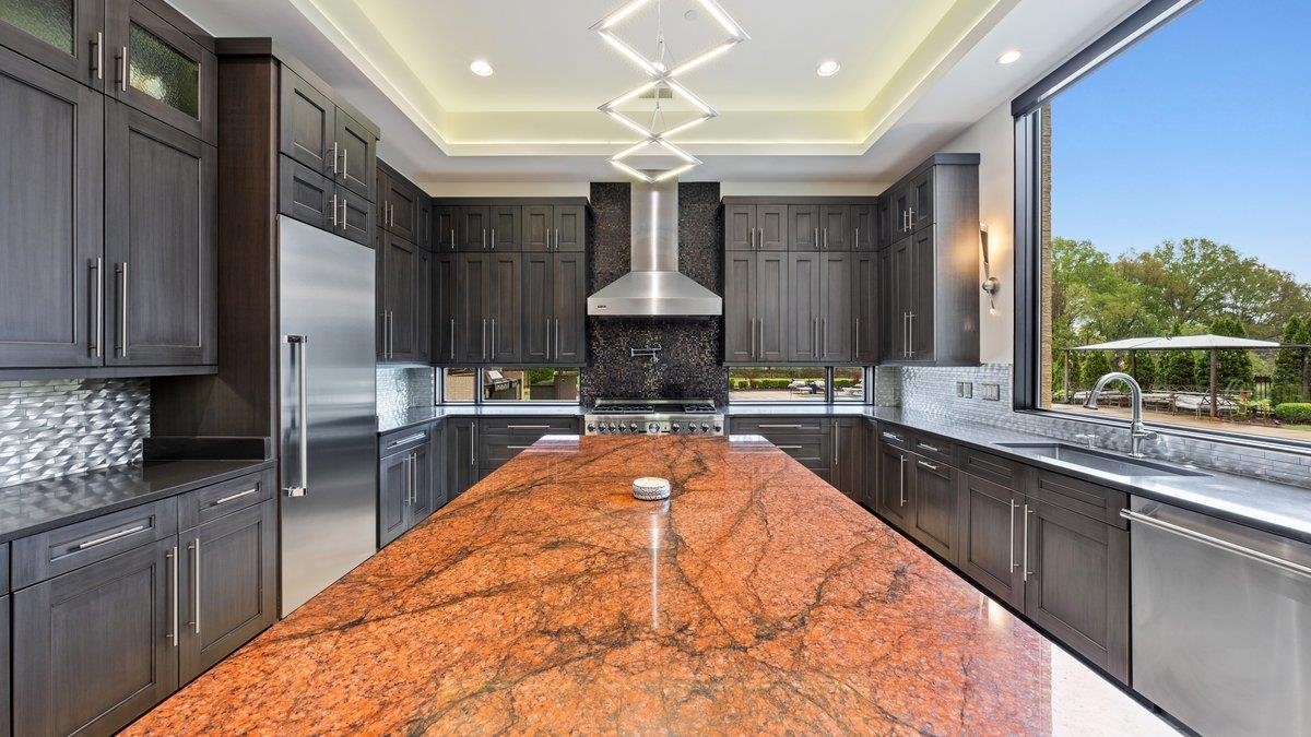 9942 Legends Drive Collierville, TN 38139 - Photo 15 of 40 a kitchen with stainless steel appliances granite countertop a stove a sink and a refrigerator
