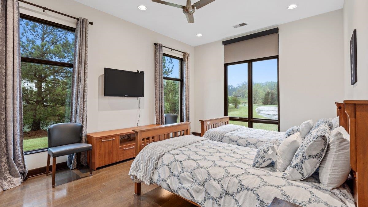 9942 Legends Drive Collierville, TN 38139 - Photo 29 of 40 a bedroom with a large bed and a flat screen tv