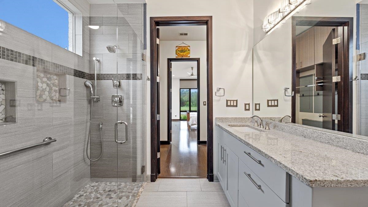 9942 Legends Drive Collierville, TN 38139 - Photo 30 of 40 a bathroom with a granite countertop sink mirror and shower