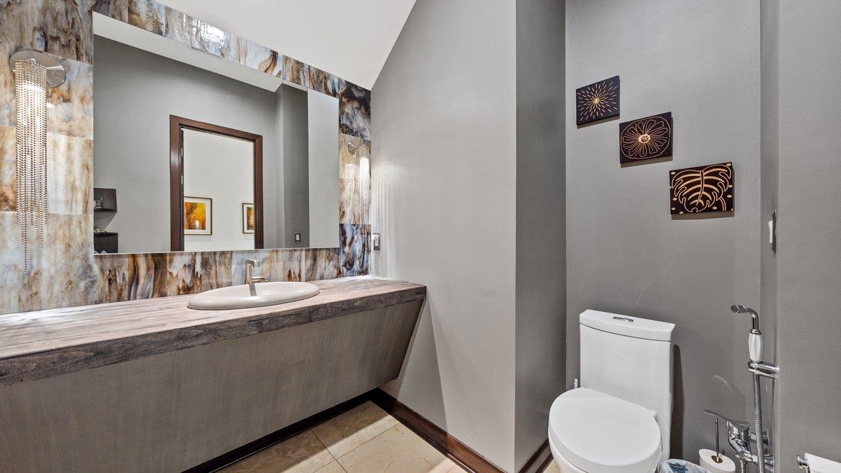 9942 Legends Drive Collierville, TN 38139 - Photo 35 of 40 a bathroom with a granite countertop toilet sink and mirror