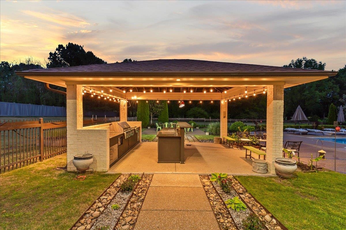 9942 Legends Drive Collierville, TN 38139 - Photo 39 of 40 a view of a patio with dining table and chairs with a ocean view