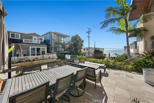 a view of a patio with table and chairs and potted plants