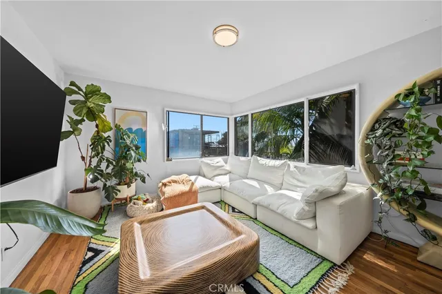 a living room with fireplace furniture and a floor to ceiling window