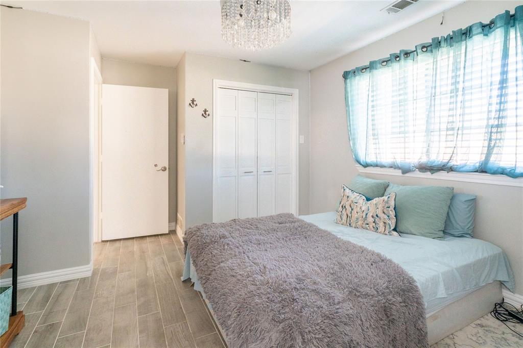 1246 Meadow Way Terrell, TX 75160 - Photo 20 of 39 a bedroom with a large bed and a chandelier
