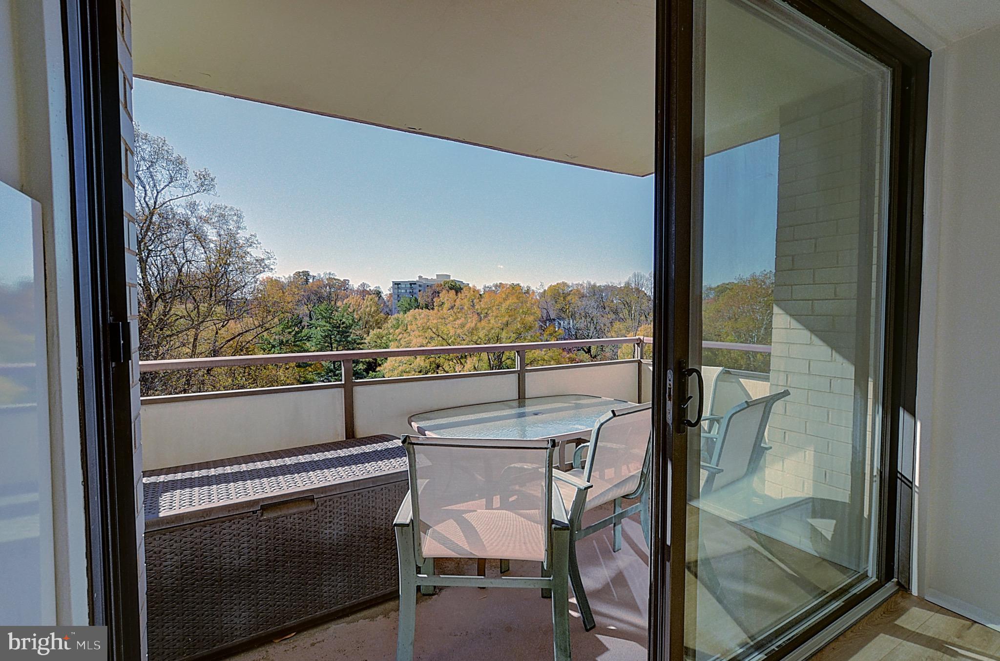 5225 Pooks Hill Road, Unit 911N Bethesda, MD 20814 - Photo 11 of 12 a view of a balcony with furniture and a floor to ceiling window