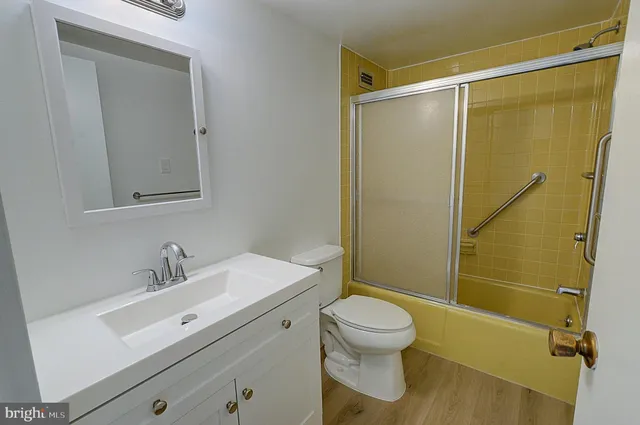 a bathroom with a sink mirror vanity and toilet