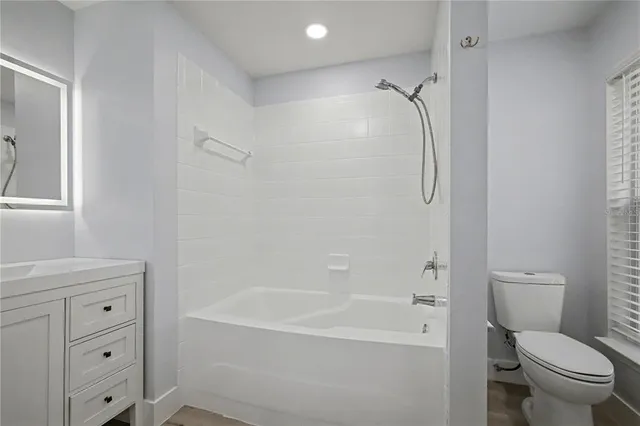 a bathroom with a bathtub toilet and shower