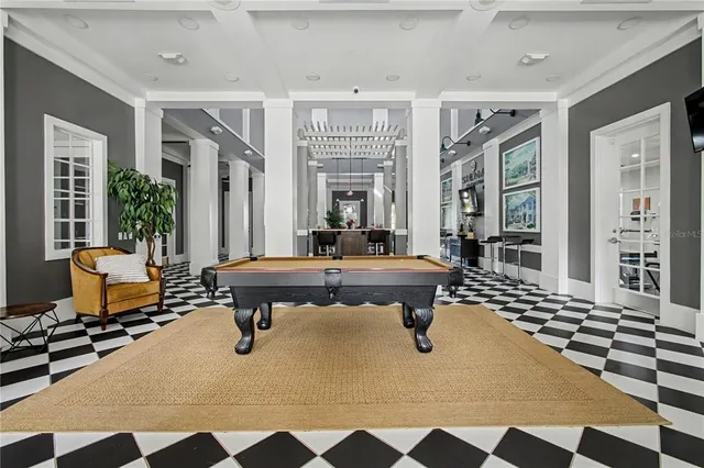 a living room with furniture a rug and a large window