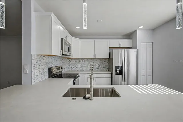 a kitchen with a cabinets and a refrigerator