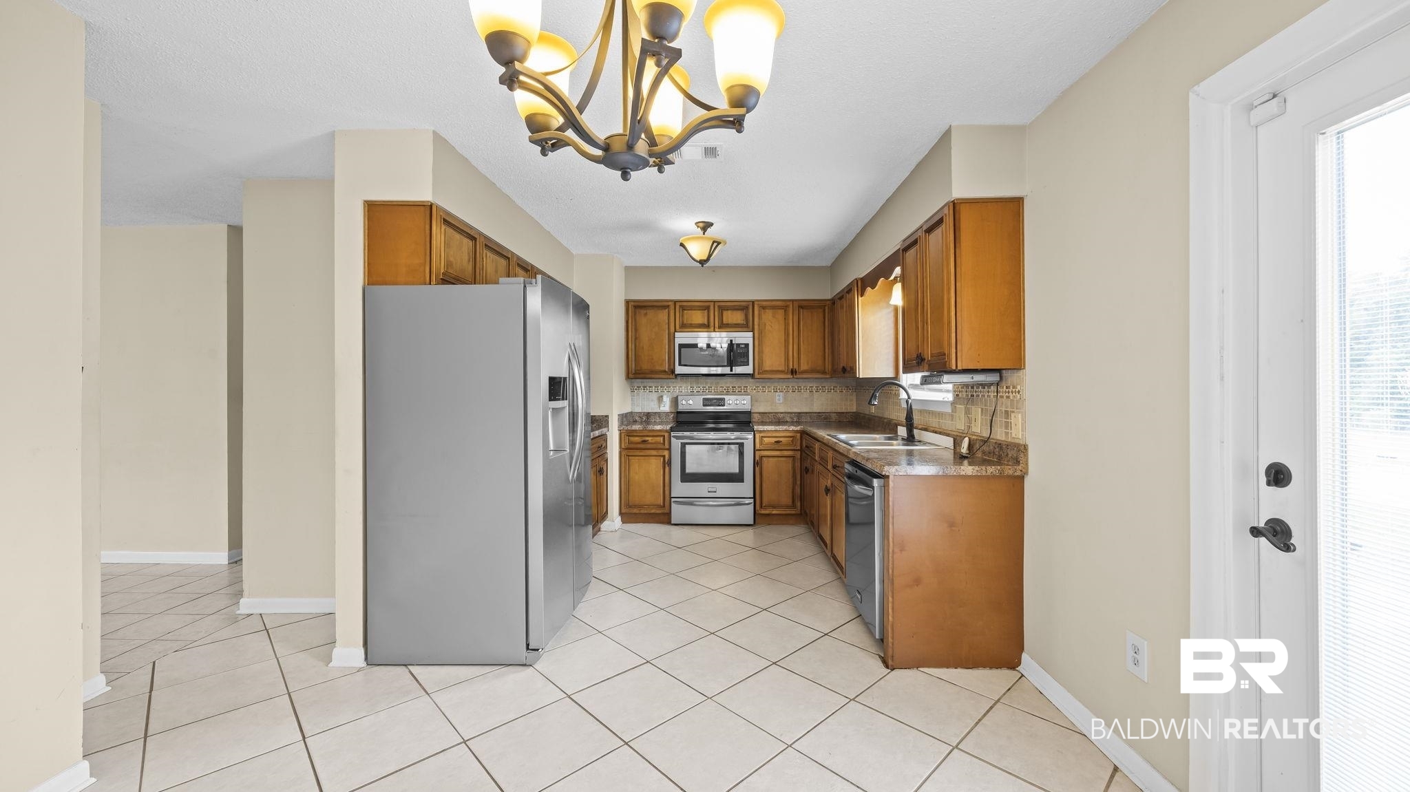 15096 Highland Circle Foley, AL 36535 - Photo 15 of 52 Kitchen featuring wood cabinetry, stainless steel appliances, and a tile backsplash