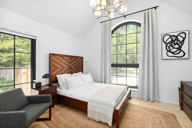 a bedroom with a bed and a window