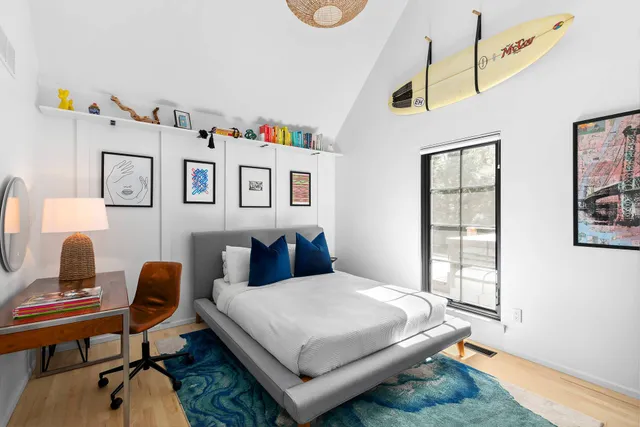 a bedroom with a bed and a desk