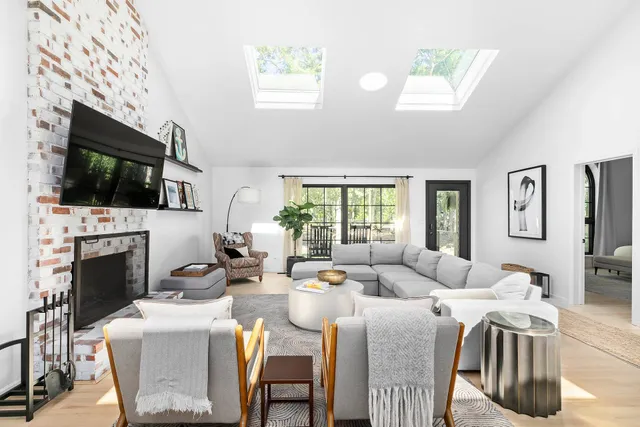 a living room with fireplace furniture and a flat screen tv