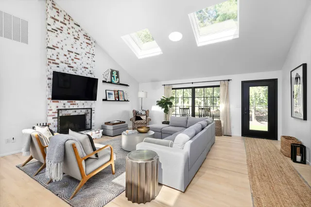 a living room with fireplace furniture and a flat screen tv