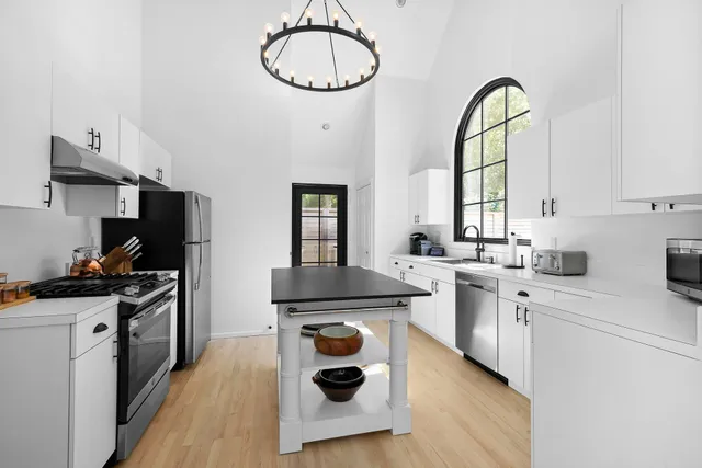 a kitchen with a sink a stove cabinets and counter space